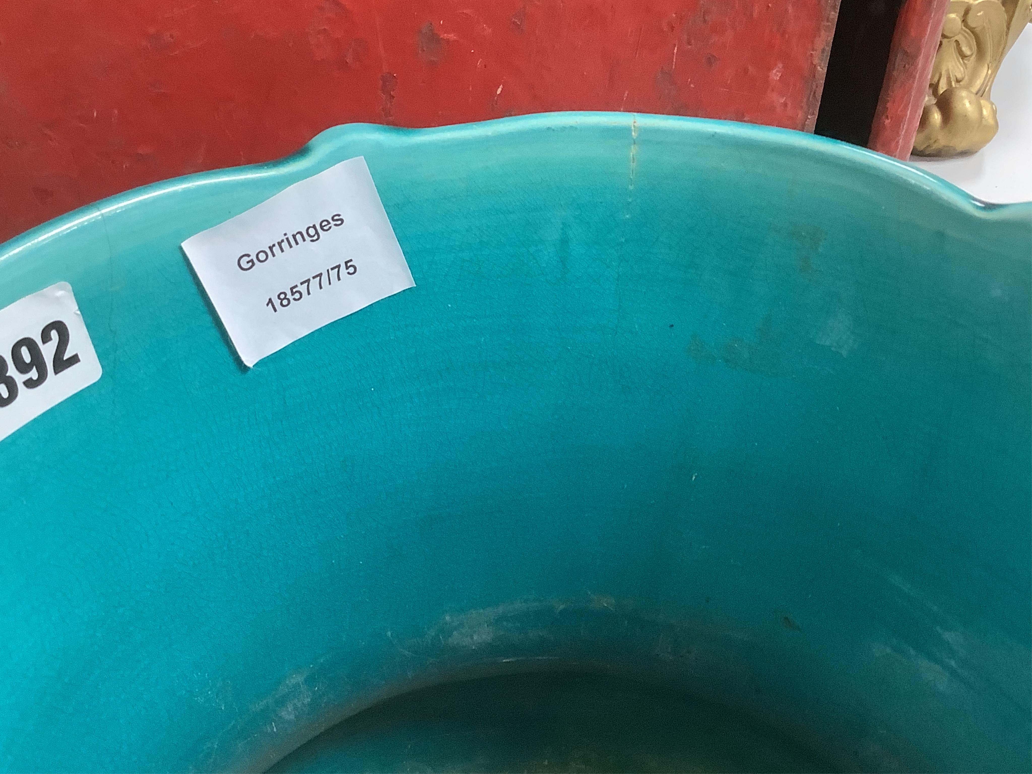 A Burmantofts style turquoise glazed jardiniere and a similar larger stand, decorated in relief, 90cm high